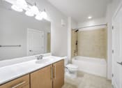 Thumbnail 36 of 64 - A bathroom with a white sink, toilet, and bathtub.