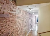 Thumbnail 8 of 50 - an exposed brick wall in a hallway of a house
