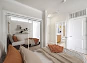 Thumbnail 12 of 64 - A bedroom with a bed, a chair, and a mirror.
