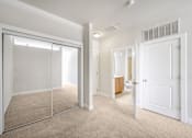 Thumbnail 35 of 64 - A room with a white door and a mirror on the wall.