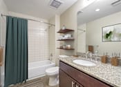 Thumbnail 4 of 50 - a bathroom with a sink and a toilet and a shower