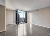 Thumbnail 23 of 50 - an empty living room with white walls and a large window