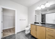 Thumbnail 22 of 64 - A bathroom with a toilet, sink, and mirror.
