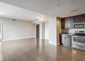 Thumbnail 25 of 50 - a kitchen with stainless steel appliances and a wooden floor