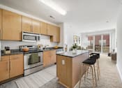 Thumbnail 1 of 64 - A kitchen with wooden cabinets and a black countertop.
