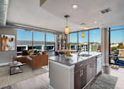Thumbnail 10 of 50 - an open kitchen and living room with a view of the city