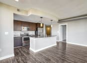 Thumbnail 17 of 50 - an open kitchen and living room with wood flooring
