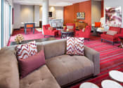 Thumbnail 37 of 50 - a living room with a bunch of couches in it