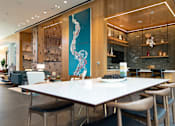 Thumbnail 5 of 37 - a dining room with a white table and chairs and a blue painting on the wall