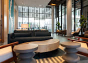 Thumbnail 10 of 37 - the lobby of a hotel with couches and tables