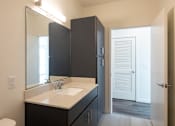 Thumbnail 11 of 37 - an empty bathroom with a sink and a mirror