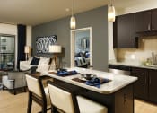 Thumbnail 2 of 47 - a kitchen and living room with a table and chairs