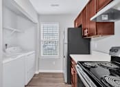 Thumbnail 7 of 25 - a kitchen with white appliances and wooden cabinets