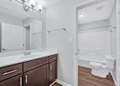 Thumbnail 12 of 25 - a bathroom with a toilet sink and bathtub