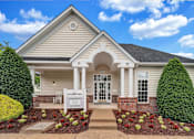 Thumbnail 32 of 32 - a picture of the front of the saratoga clubhouse with a blue sky in the background
