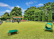Thumbnail 22 of 32 - a large grassy area with a swing set and a trampoline