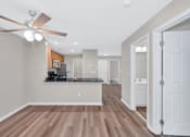 Thumbnail 5 of 32 - A kitchen with a fan and wooden floors.