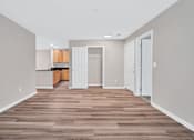 Thumbnail 4 of 32 - A room with wooden flooring and white walls.