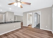 Thumbnail 6 of 32 - A spacious kitchen with a ceiling fan and wooden flooring.