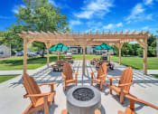 Thumbnail 17 of 18 - Cozy fire pit with seating and covered grilling pavilion