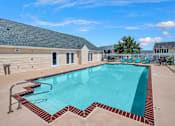 Thumbnail 19 of 25 - our resort style swimming pool is next to our building with chairs and a house
