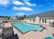Thumbnail 18 of 25 - our resort style pool is open to the community and is surrounded by chairs and tables