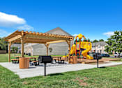 Thumbnail 17 of 25 - a playground and pavilion in a park with a yellow