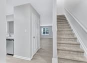 Thumbnail 2 of 25 - a renovated living room and staircase with a kitchen in a house