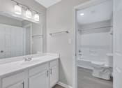 Thumbnail 21 of 25 - a bathroom with a sink and a toilet and a shower