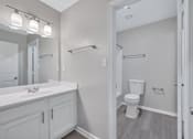 Thumbnail 22 of 25 - a bathroom with a sink and a toilet and a mirror