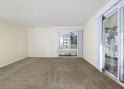 Thumbnail 5 of 23 - a living room with carpet and sliding glass doors to a balcony