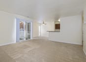 Thumbnail 12 of 23 - an empty living room with a door to a balcony