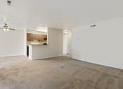 Thumbnail 13 of 23 - an empty living room and kitchen with a ceiling fan