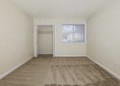 Thumbnail 15 of 23 - an empty living room with carpet and a window
