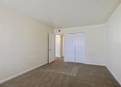 Thumbnail 16 of 23 - a spacious living room with carpeting and white walls
