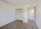 Thumbnail 7 of 23 - an empty bedroom with a closet and a door to a closet