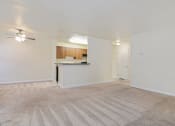 Thumbnail 3 of 23 - an empty living room and kitchen with a ceiling fan