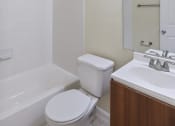 Thumbnail 17 of 23 - a bathroom with a toilet and a sink and a bath tub