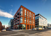 Thumbnail 27 of 37 - a rendering of a large building on a city street