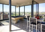 Thumbnail 46 of 50 - a living room with a pool table and a view of the city