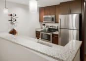 Thumbnail 30 of 50 - a kitchen with granite counter tops and stainless steel appliances