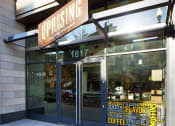 Thumbnail 49 of 50 - a view of the front of a coffee shop with a sign on the front door