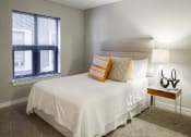 Thumbnail 34 of 50 - a bedroom with a large white bed and a window