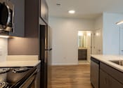 Thumbnail 18 of 37 - a kitchen with an island and a sink and a refrigerator