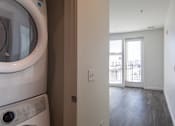 Thumbnail 20 of 37 - a laundry room with a washer and dryer and a door to a balcony