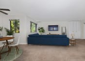Thumbnail 3 of 15 - a living room with a blue couch and a dining room table