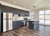 Thumbnail 13 of 37 - an empty kitchen with stainless steel appliances and a large window