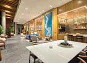 Thumbnail 6 of 37 - a lobby of a hotel with a table and chairs
