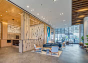 Thumbnail 7 of 37 - the lobby of a building with a lobby area with couches and chairs