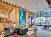Thumbnail 4 of 37 - the lobby of an office building with a blue mural on the wall and a couch